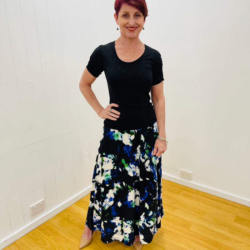 Arulean print long aline skirt stretch fabric black background with a green, cobalt blue and white floral print flat stretch waistband True Reflections Clothing Gymea