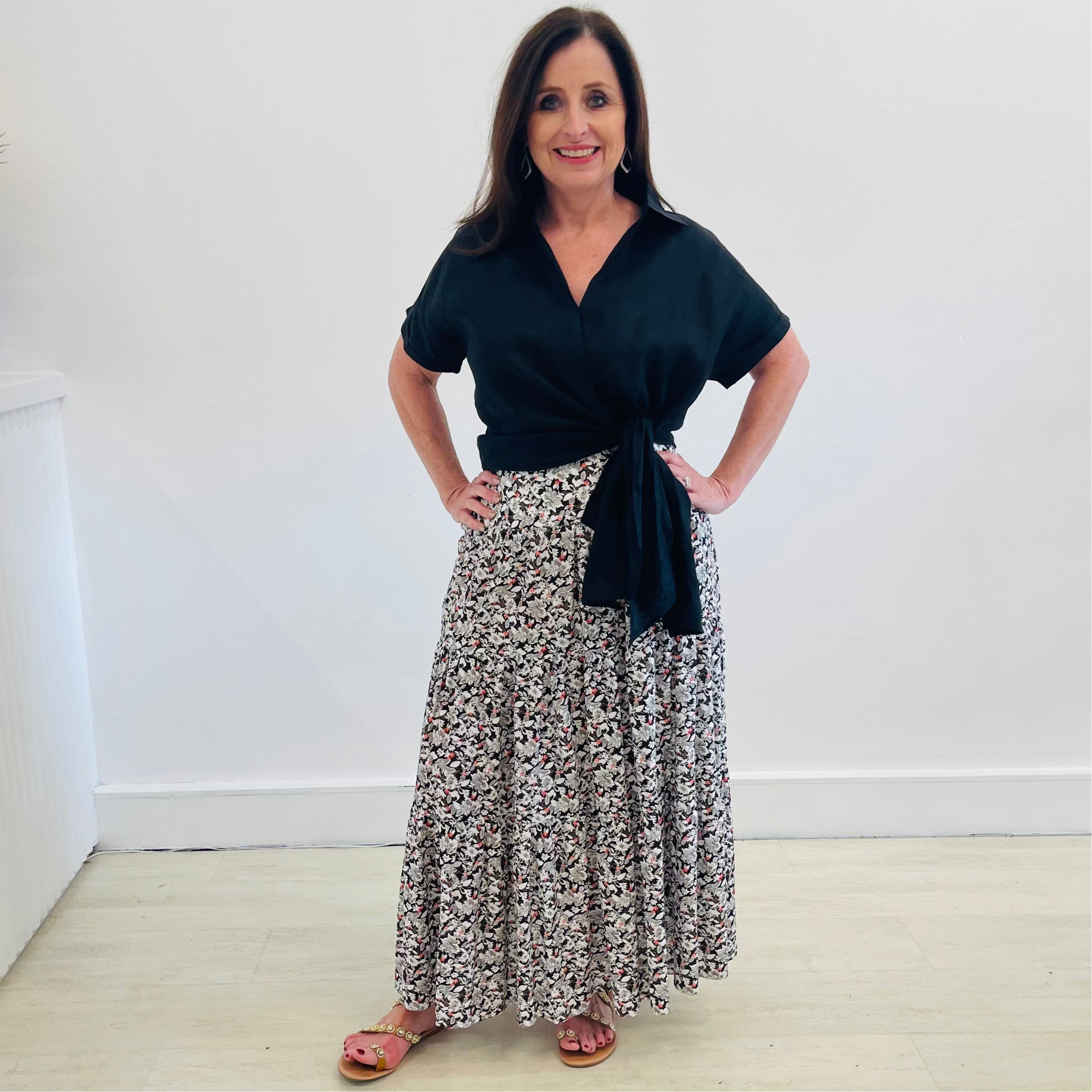 Maxi, long, tiered skirt in a black, white & red pattern print, worn with short sleeve, side tie on waistline, v neckline,collared, women's, linen shirt