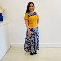 Long Aline Skirt with flat stretch waistband polyester spandex blend a navy background with gold, white and blues in a mandala print