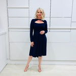 Penelope dress in deep navy blue, worn by model- elegant long sleeve design, knee length, with modern neckline.