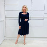 Penelope dress in deep navy blue, worn by model- elegant long sleeve design, knee length, with modern neckline.