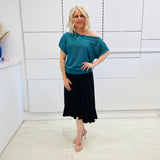 Stunning off the shoulder emerald green top with delicate shimmer. Flattering relaxed fit cut with stretch waistband for style and fit. Worn with black stretch skirt with asymmetrical hemline small ruffle detail.