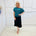 Stunning off the shoulder emerald green top with delicate shimmer. Flattering relaxed fit cut with stretch waistband for style and fit. Worn with black stretch skirt with asymmetrical hemline small ruffle detail.
