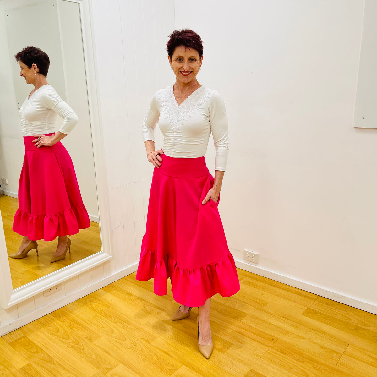 Hot Pink Polyester Blend Midi length skirt. Ruffled hemline. Flat wide waistband. Centre back zipper. Pockets.