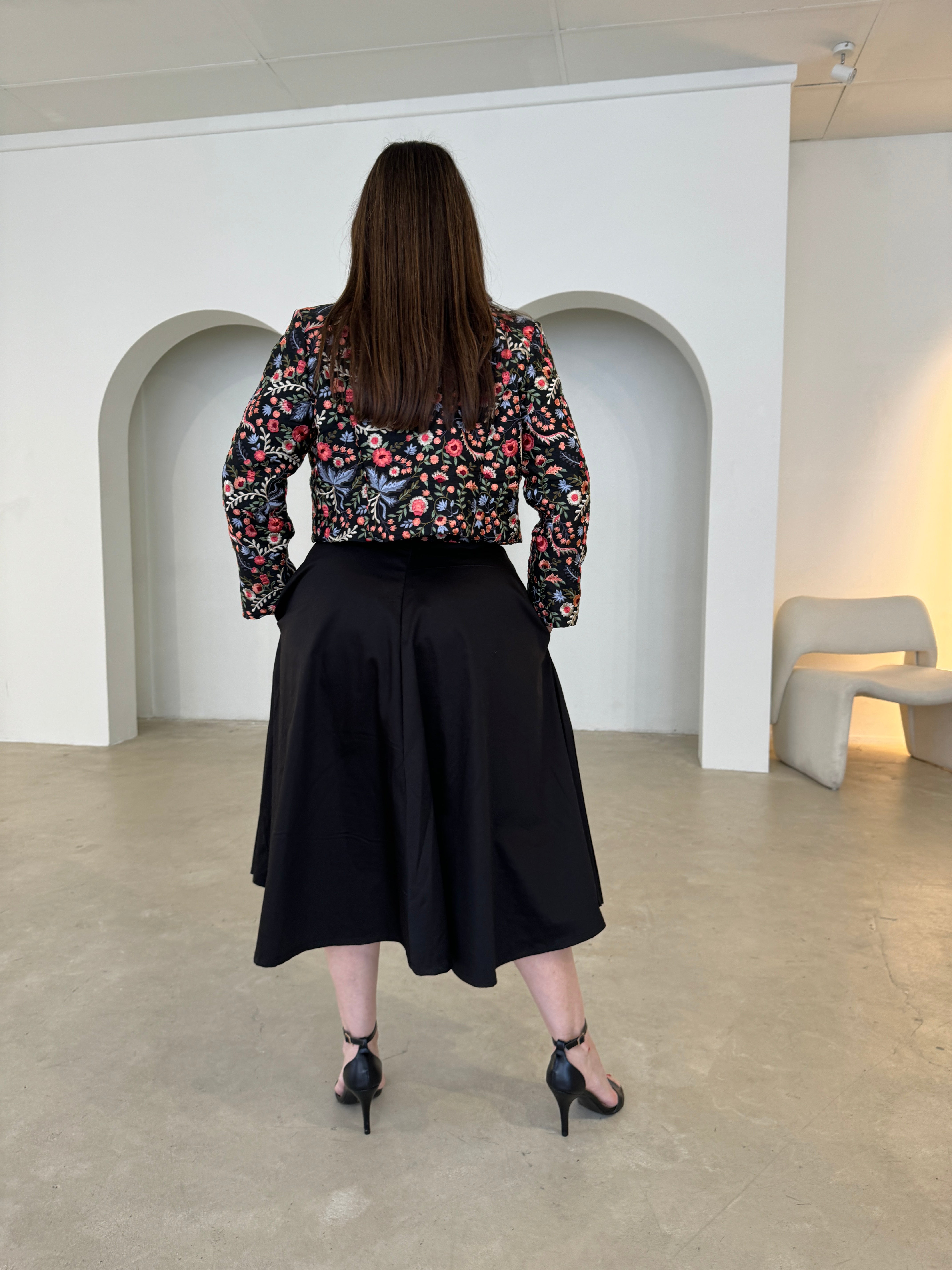 Black short, bolero jacket with all over multi coloured embroidery.With strapless  dress.