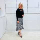 Noir garden-Black and white floral print, Rachel  Ruffle skirt, with elastic stretch waist. Worn on model with black bamboo , long sleeve, split front, Sabrina top. 