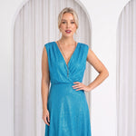 Model in white room wearing blue dress