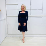 Penelope dress in deep navy blue, worn by model- elegant long sleeve design, knee length, with modern neckline.