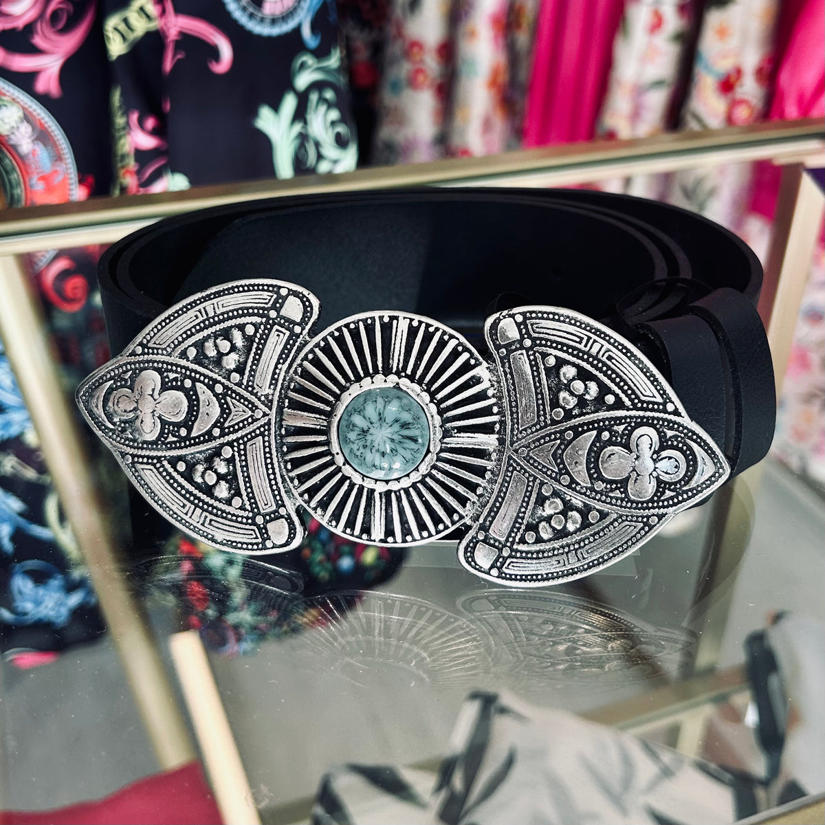 Black leather embossed belt with a silver buckle intricate design with a turquoise stone in the centre. Made in Greece