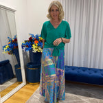 Woman wearing Harper top green and colourful skirt 