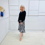 Noir garden-Black and white floral print, Rachel  Ruffle skirt, with elastic stretch waist. Worn on model with black bamboo , long sleeve, tie front, v-neckline top.