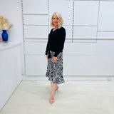 Noir garden-Black and white floral print, Rachel  Ruffle skirt, with elastic stretch waist. Worn on model with black bamboo , long sleeve, tie front, v-neckline top.
