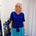 Woman wearing blue top and green skirt 