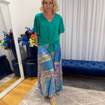 Woman wearing Harper top green and colourful skirt 