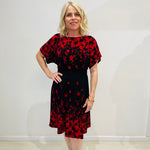 Black base colour dress with red floral border print on neckline and hemline. Short sleeve & knee length dress. 