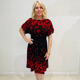 Black base colour dress with red floral border print on neckline and hemline. Short sleeve & knee length dress. 