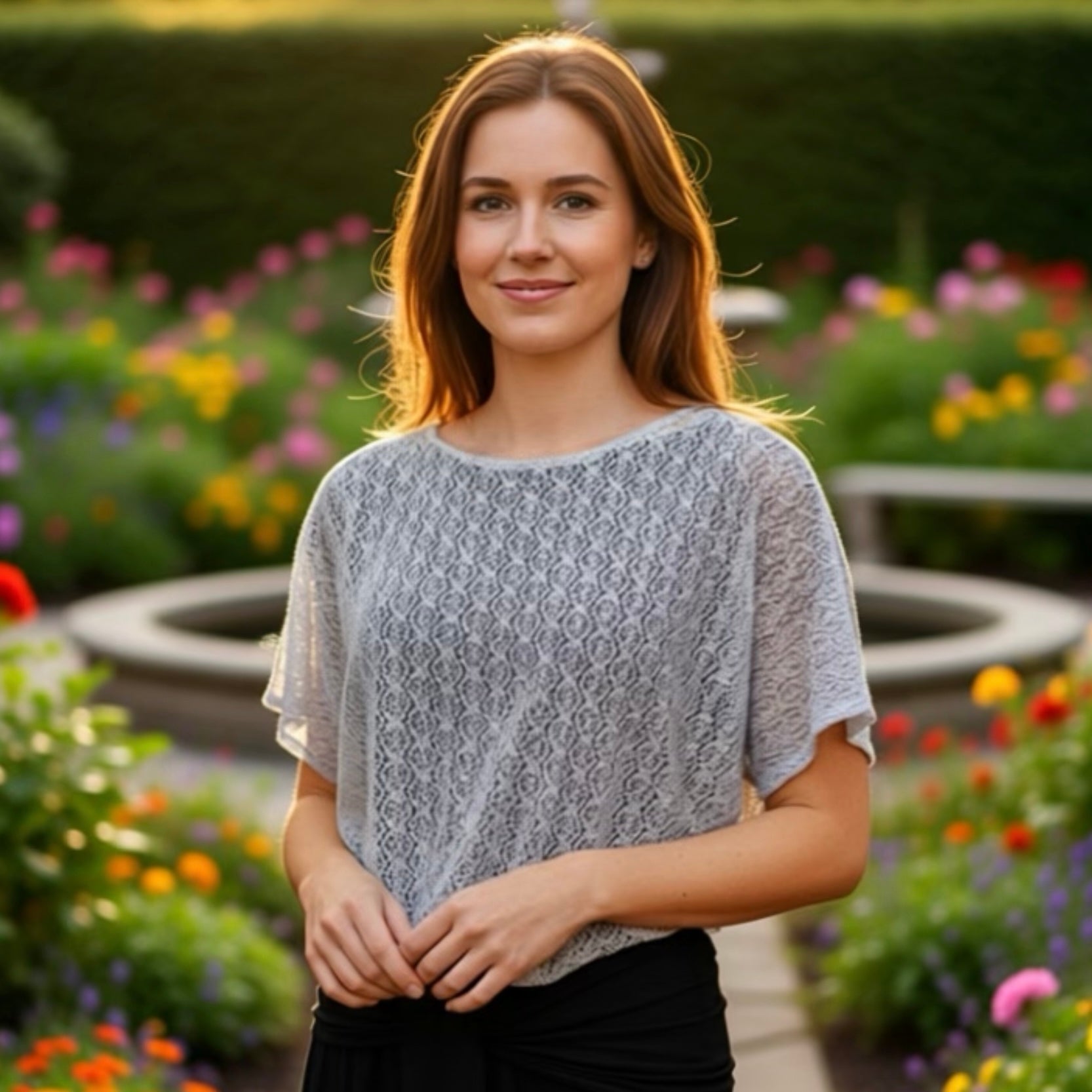 Woman standing in a garden with colorful flowers in the background