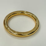 Gold bangle on a white background