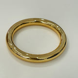 Gold bangle on a white background
