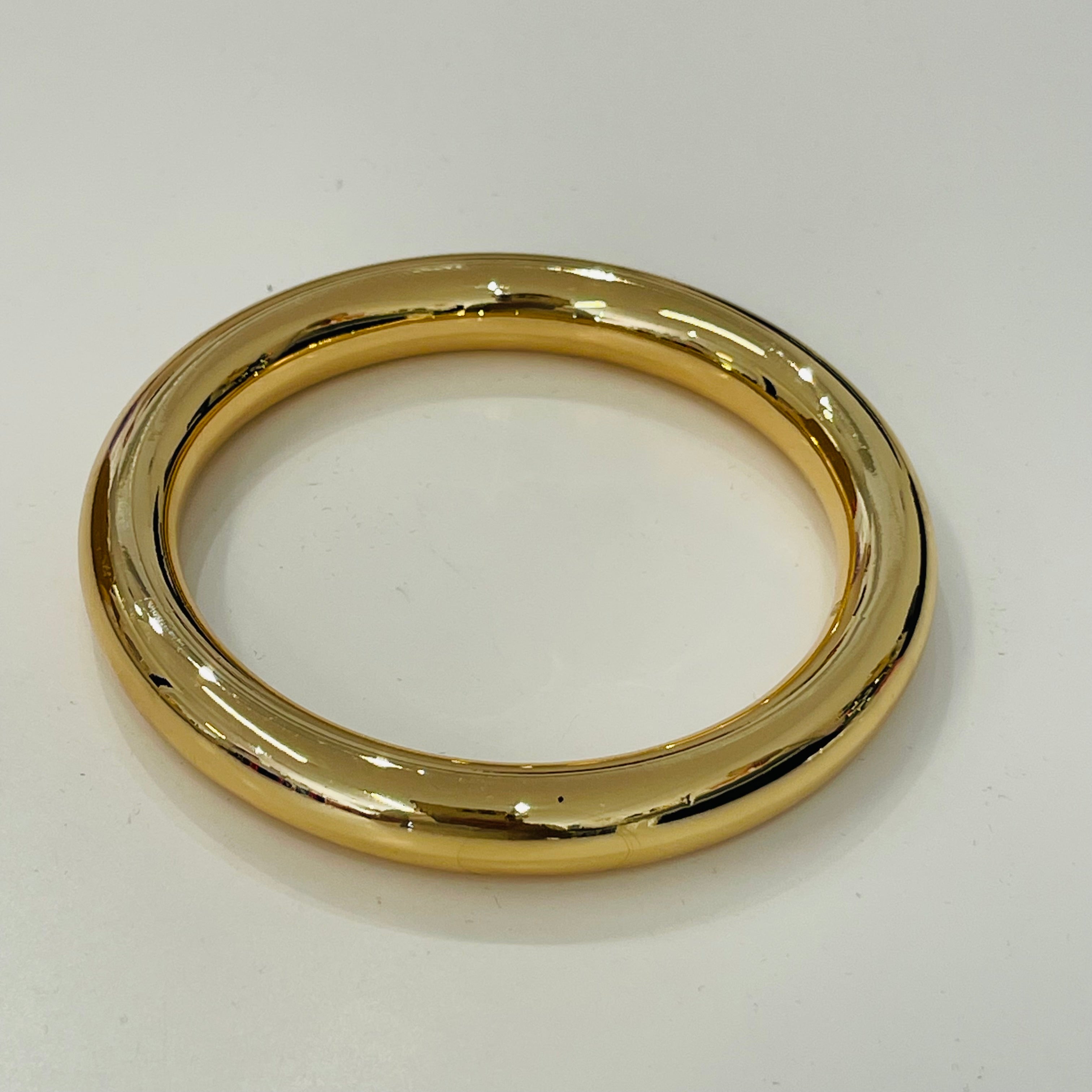 Gold bangle on a white background