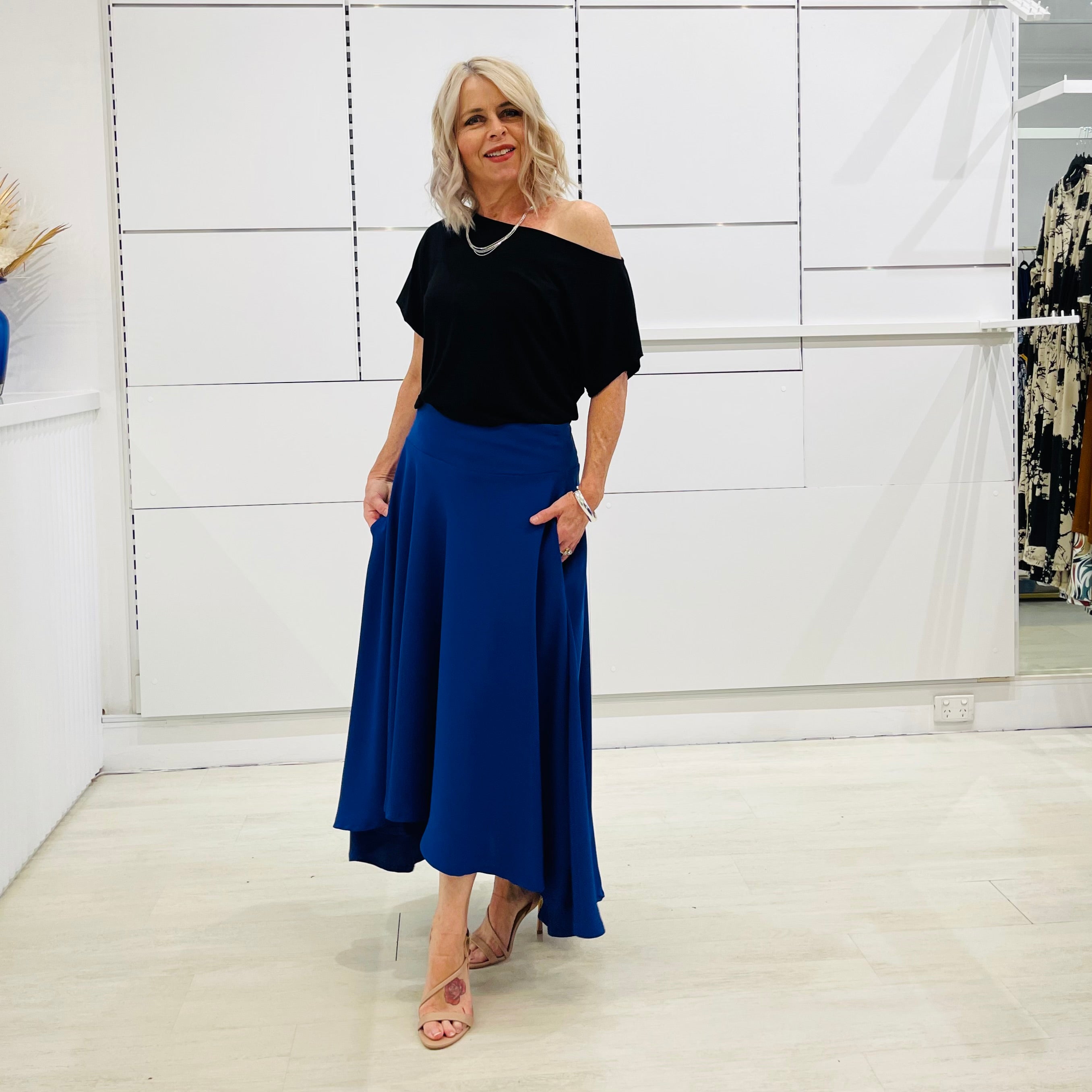 Royal blue,long, maxi,dipped hemline, flat fitted waistband ,skirt with pockets. Worn with black ff the shoulder top