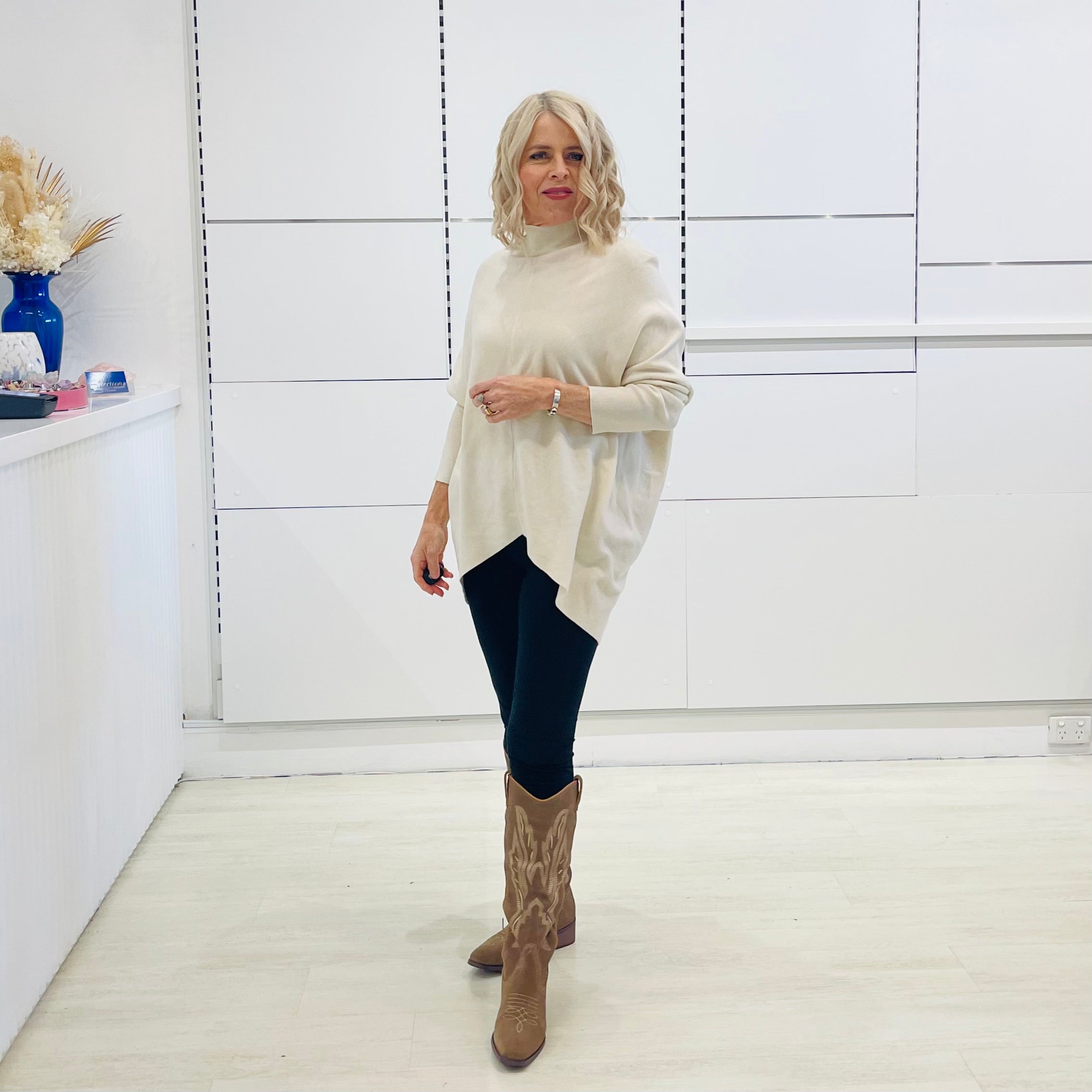 Cream knit jumper/sweater.Long sleeve, high neckline, asymmetrical hemline woolen winter jumper.