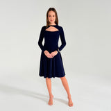 Woman wearing a navy blue dress with long sleeves on a white background
