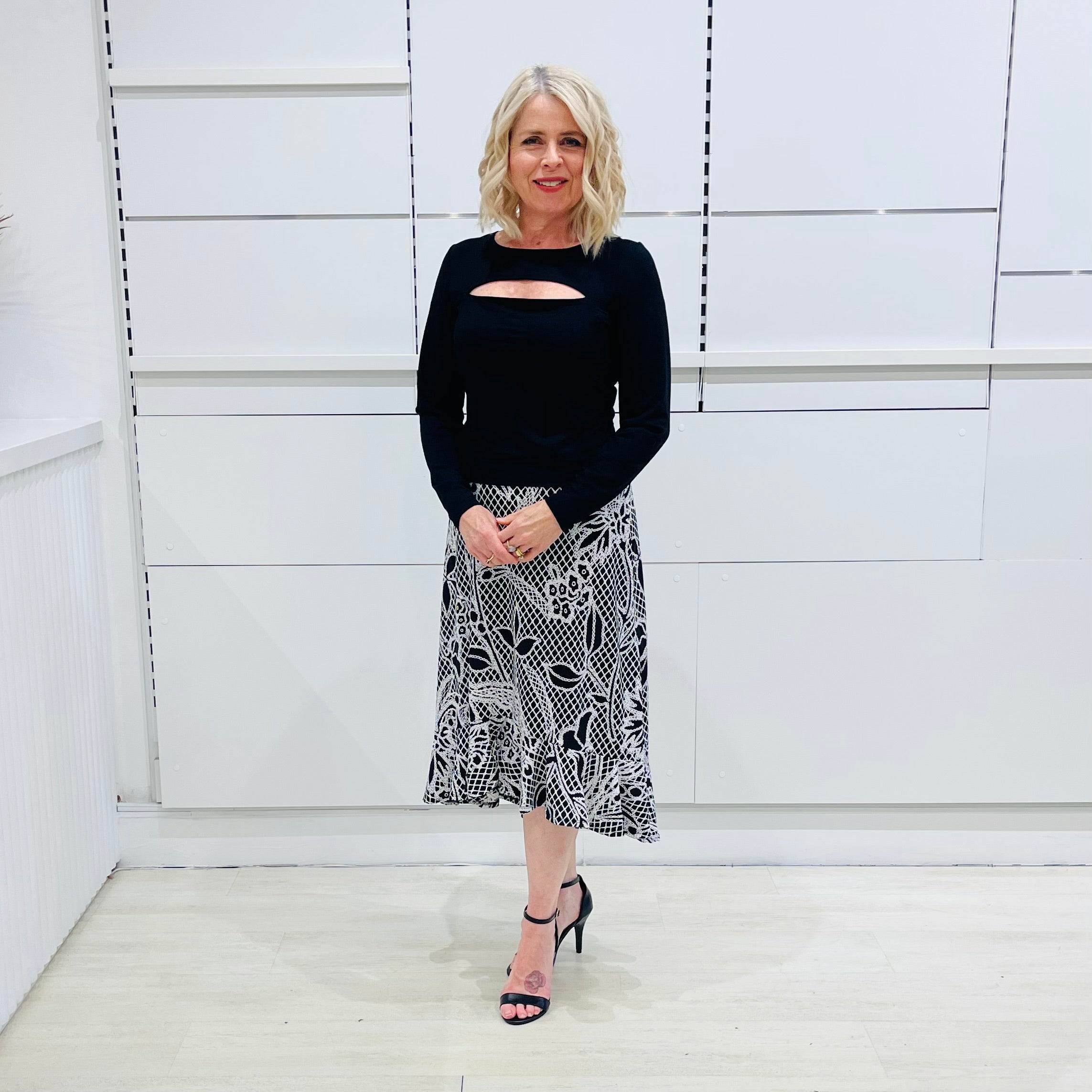 Noir garden-Black and white floral print, Rachel  Ruffle skirt, with elastic stretch waist. Worn on model with black bamboo , long sleeve, split front, Sabrina top. 