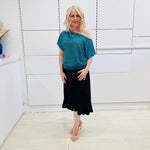 Stunning off the shoulder emerald green top with delicate shimmer. Flattering relaxed fit cut with stretch waistband for style and fit. Worn with black stretch skirt with asymmetrical hemline small ruffle detail.