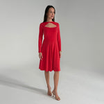 Woman wearing a red dress against a plain background