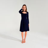Woman wearing a navy blue dress on a white background