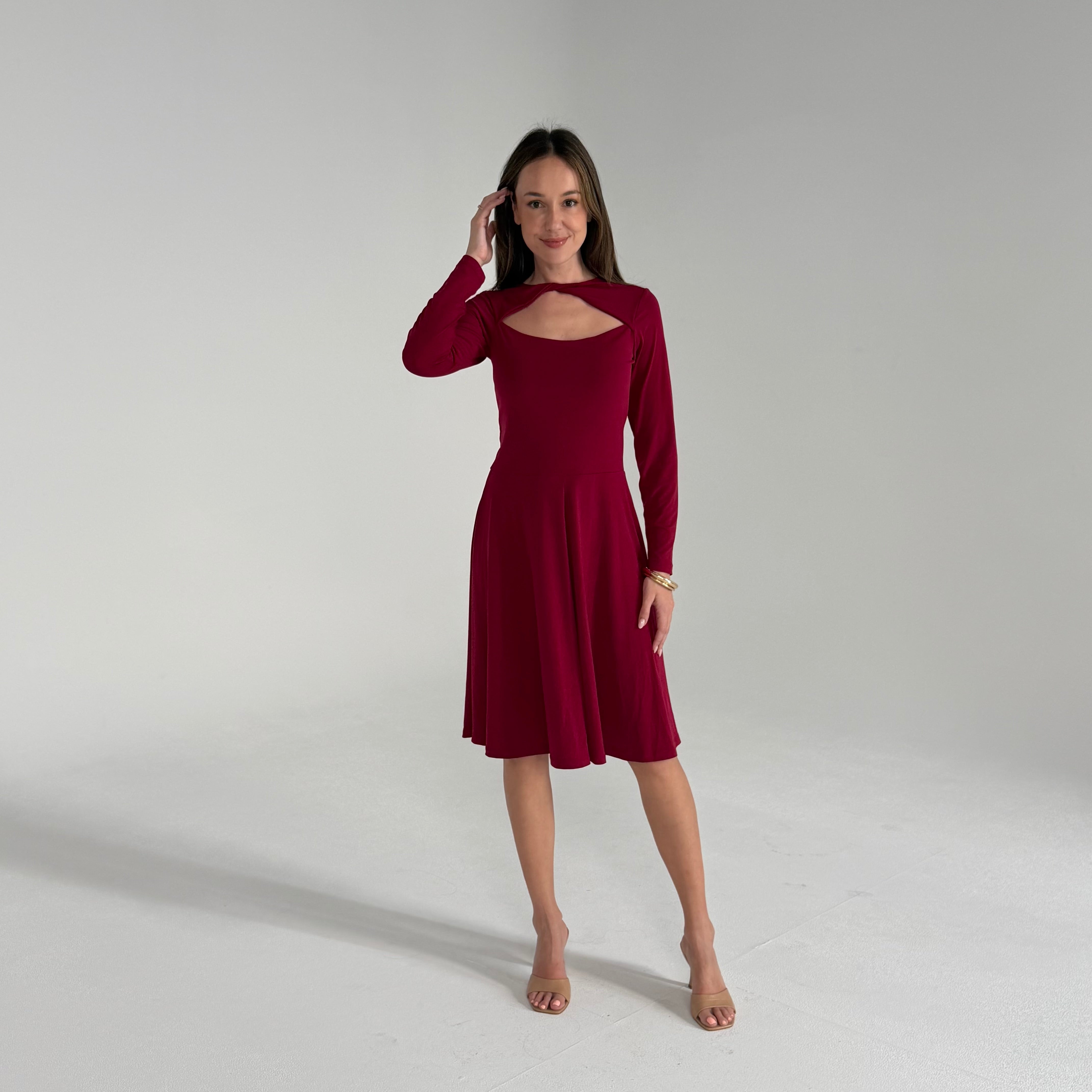 Woman wearing a burgundy dress on a plain background