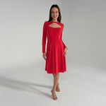 Woman wearing an orange dress on a gray background