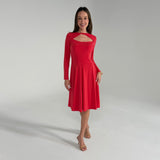 Woman wearing an orange dress on a gray background