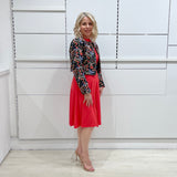 Bright watermelon pink Penelope dress on model- vibrant colour, stretch dress, with feminine silhouette, long sleeve, a-line skirt and keyhole neckline. Worn with Selena Embroidered silk bolero Jacket.