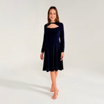 Woman wearing a navy blue dress with long sleeves on a white background