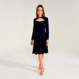 Woman wearing a navy blue dress with long sleeves on a white background