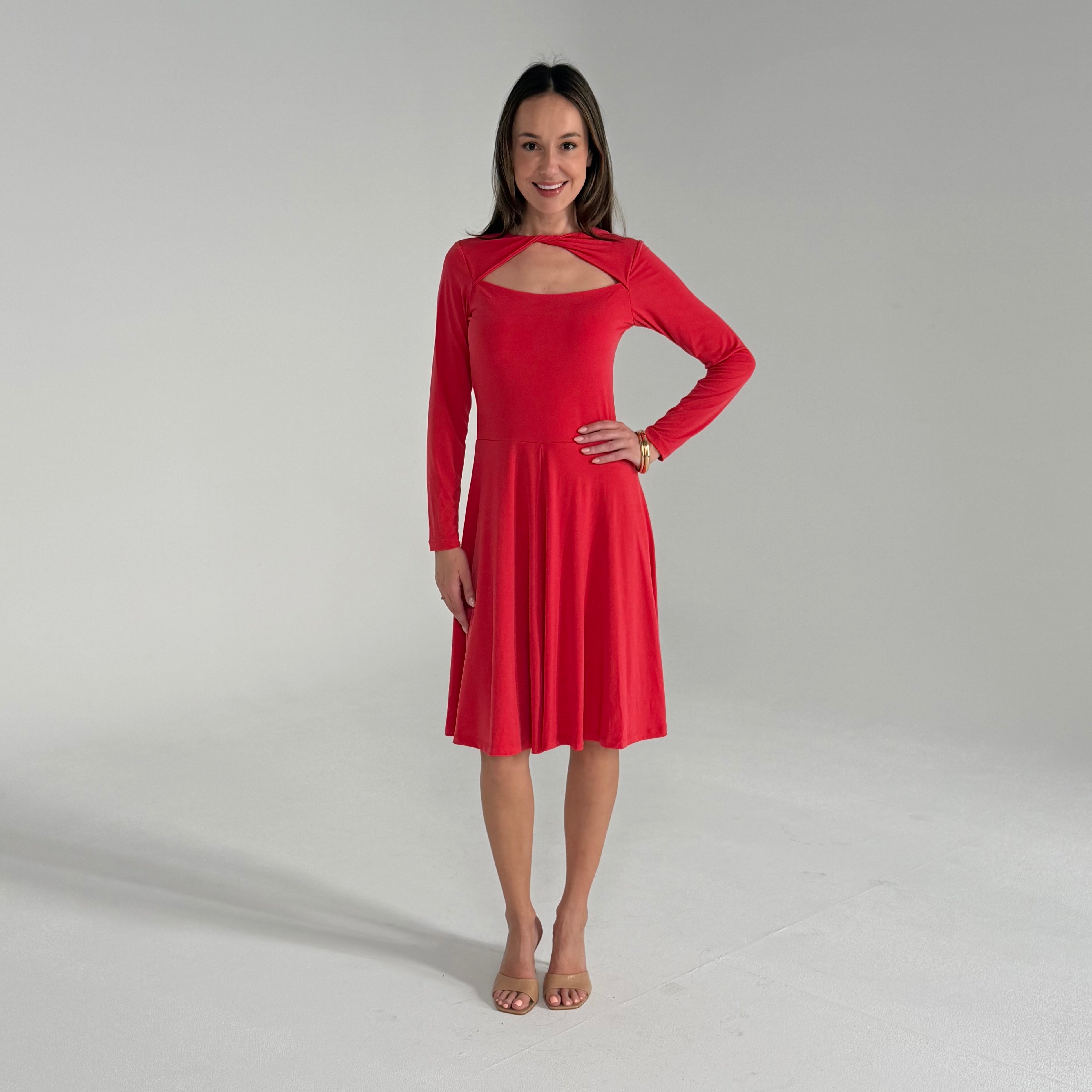 Woman wearing a red dress on a plain background
