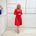 Bright watermelon pink Penelope dress on model- vibrant colour, stretch dress, with feminine silhouette, long sleeve, a-line skirt and keyhole neckline.