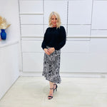 Noir garden-Black and white floral print, Rachel  Ruffle skirt, with elastic stretch waist. Worn on model with black bamboo , long sleeve,  round neckline, Gracie top.