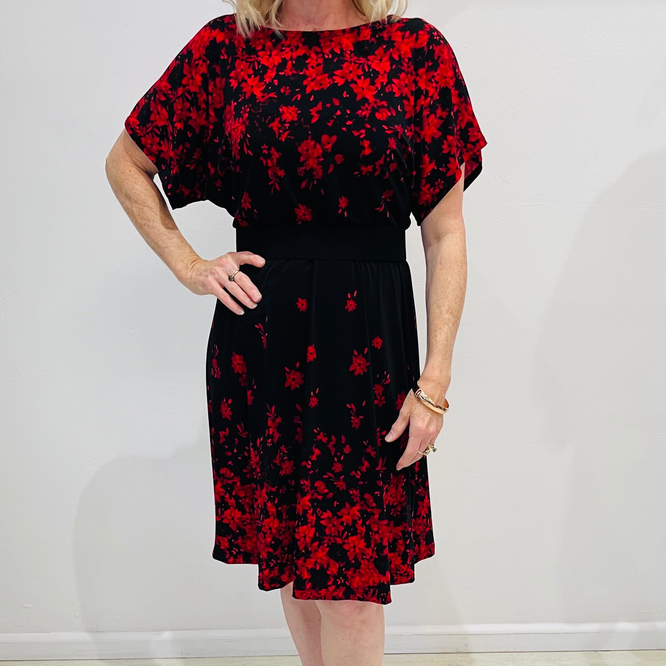 Black base colour dress with red floral border print on neckline and hemline. Short sleeve & knee length dress. 