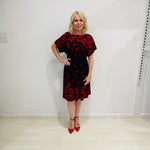 Black base colour dress with red floral border print on neckline and hemline. Short sleeve & knee length dress. 