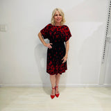 Black base colour dress with red floral border print on neckline and hemline. Short sleeve & knee length dress. 