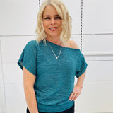 Stunning off the shoulder emerald green top with delicate shimmer. Flattering relaxed fit cut with stretch waistband for style and fit. Worn with black stretch skirt with asymmetrical hemline small ruffle detail.