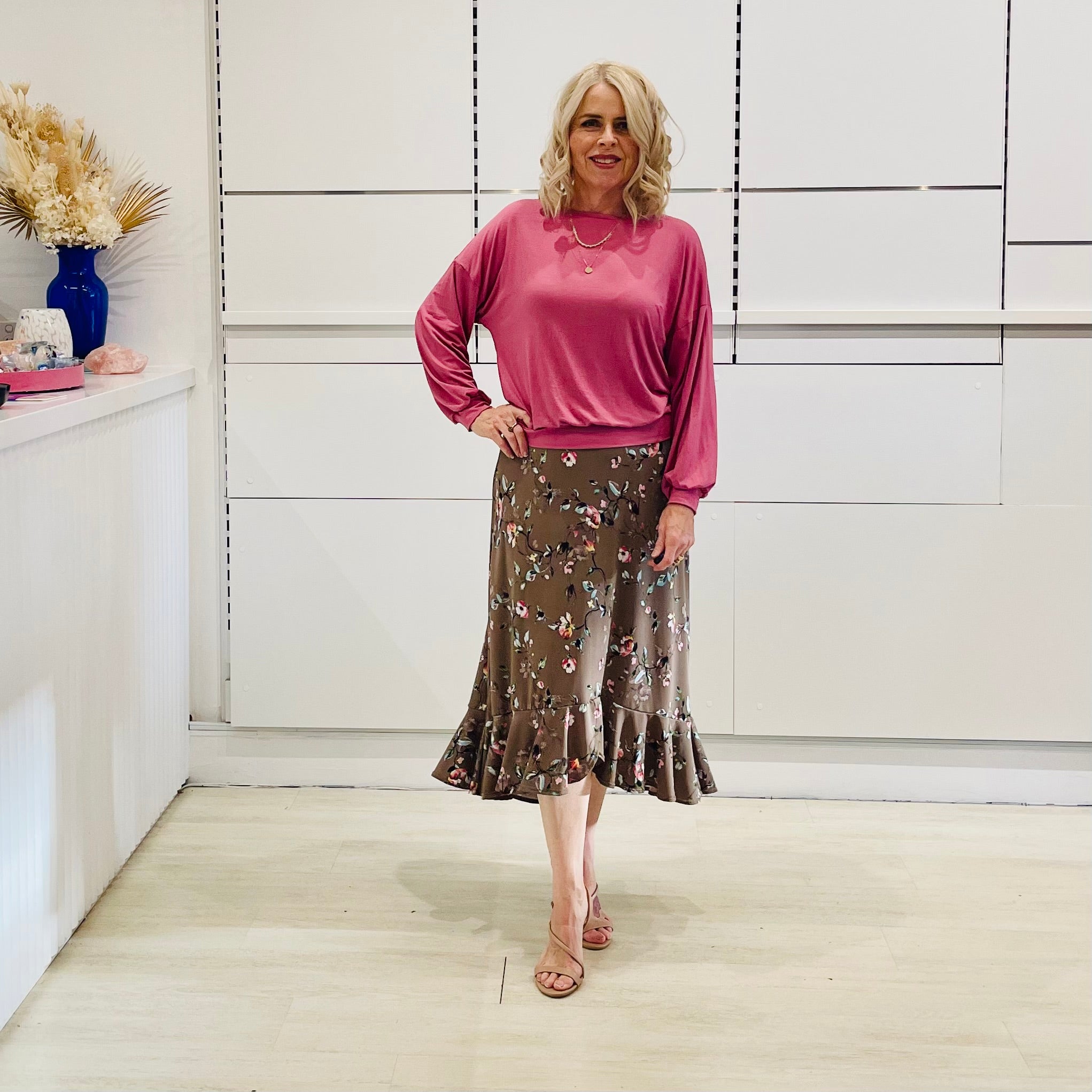 Relaxed, loose line fit top, long sleeve,with wrist cuff, round neck, waistband for shape. With soft drape midi length, brown floral skirt with soft ruffle on asymmetrical hemline.