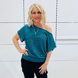 Stunning off the shoulder emerald green top with delicate shimmer. Flattering relaxed fit cut with stretch waistband for style and fit. Worn with black tailored pants.