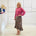 Relaxed, loose line fit top, long sleeve,with wrist cuff, round neck, waistband for shape. With soft drape midi length, brown floral skirt with soft ruffle on asymmetrical hemline.