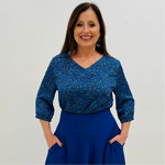 Stylish v- neck, three quarter sleeve blouse in a vibrant blue and black leopard print, paired with high-waisted sapphire blue, full circle skirt with pockets.