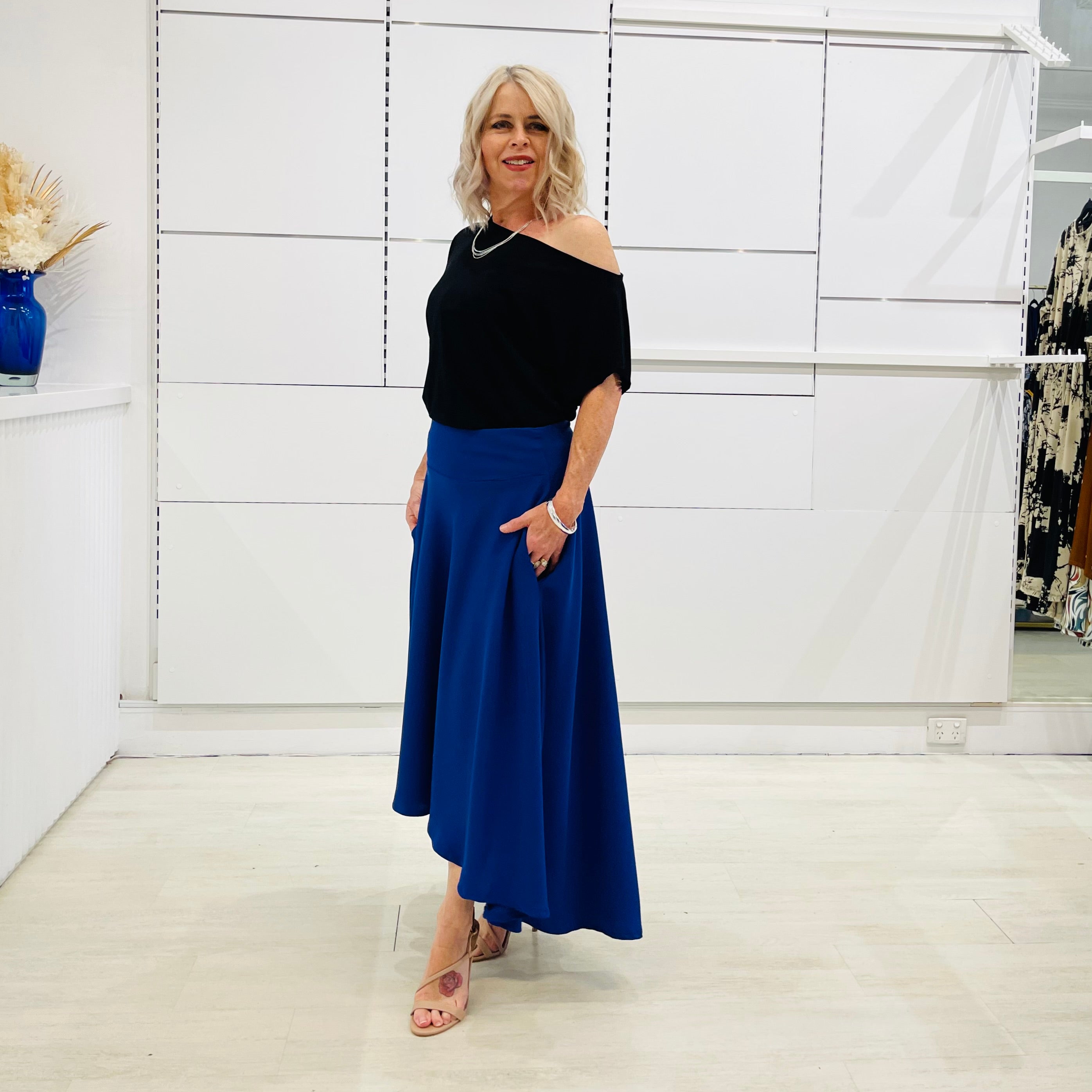 Royal blue,long, maxi,dipped hemline, flat fitted waistband ,skirt with pockets. Worn with black ff the shoulder top.