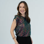 Sparkly top with black skirt on model 
